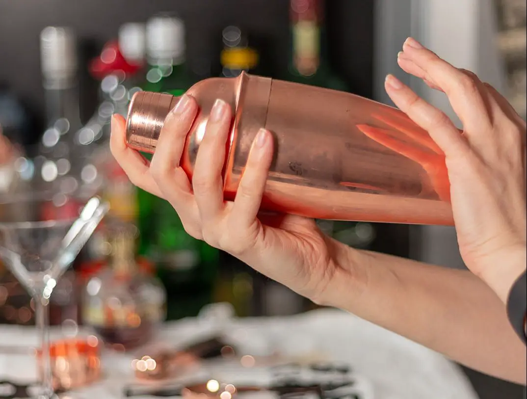 hands shaking cocktail