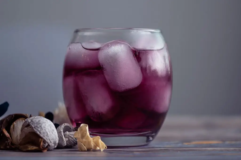 purple cocktail with gin and ice